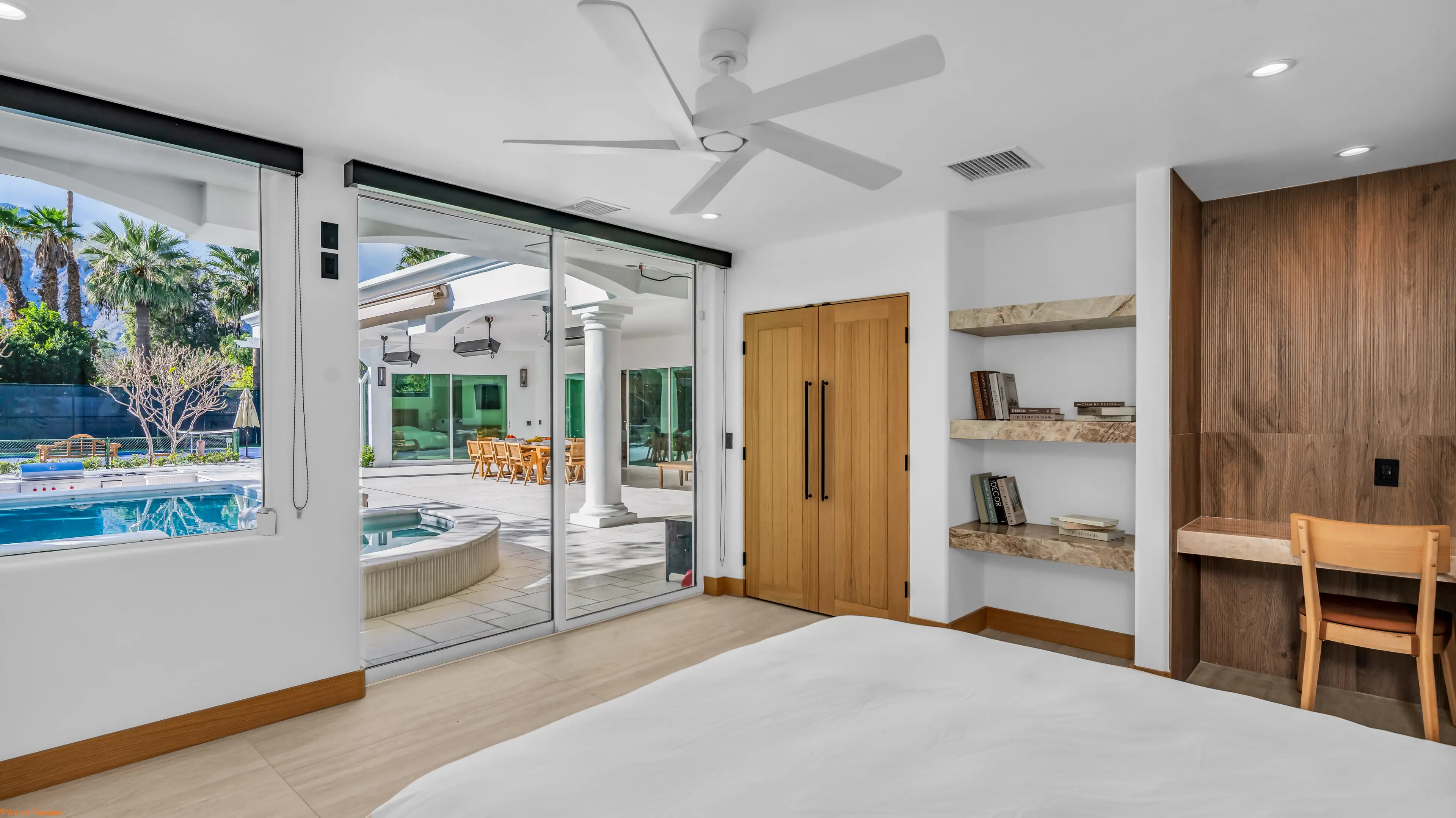 Bedroom with the glass doors drawn back onto the spa and the covered terrace.