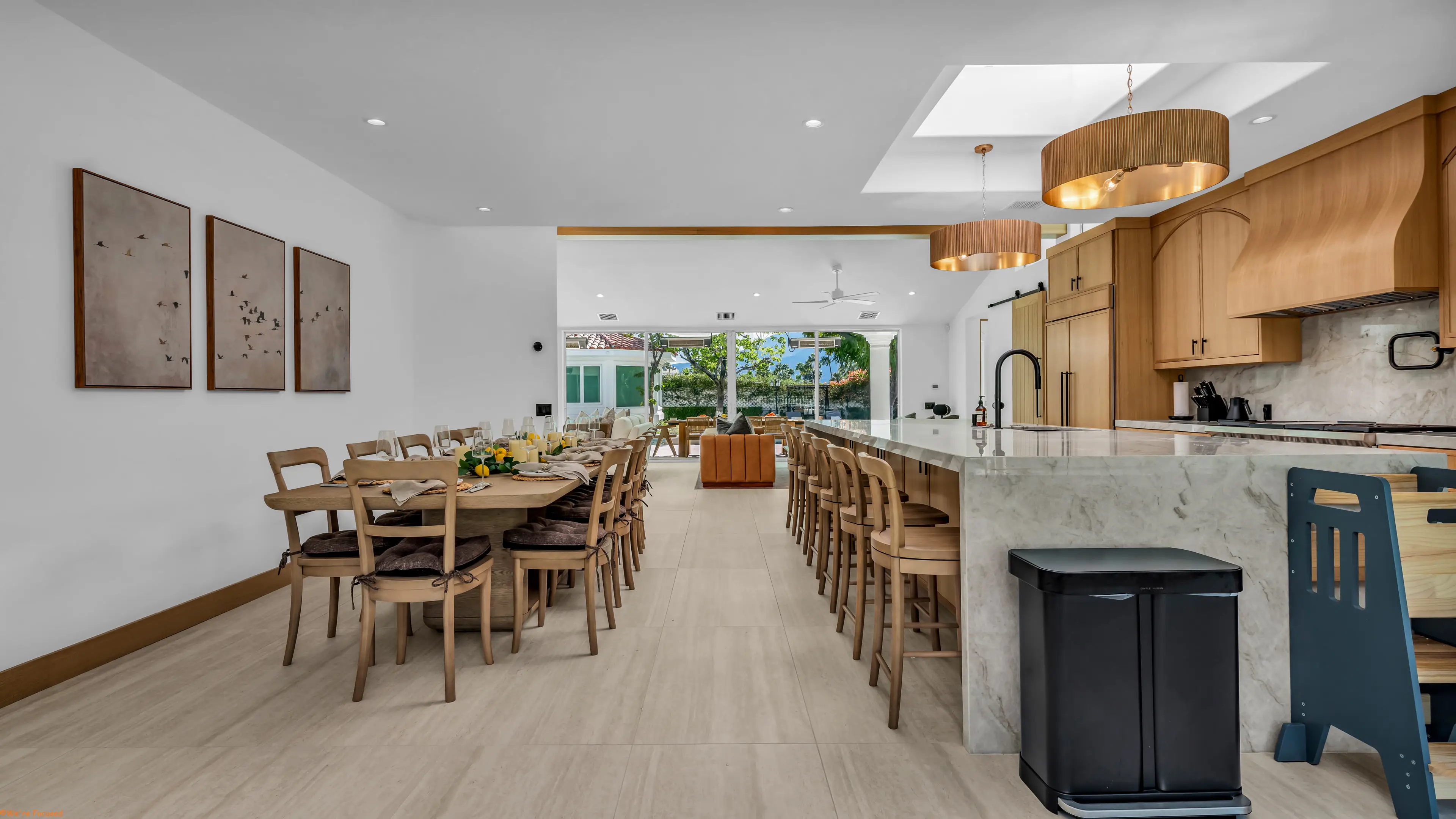 Down the length of the dining table and the kitchen island to the garden windows.