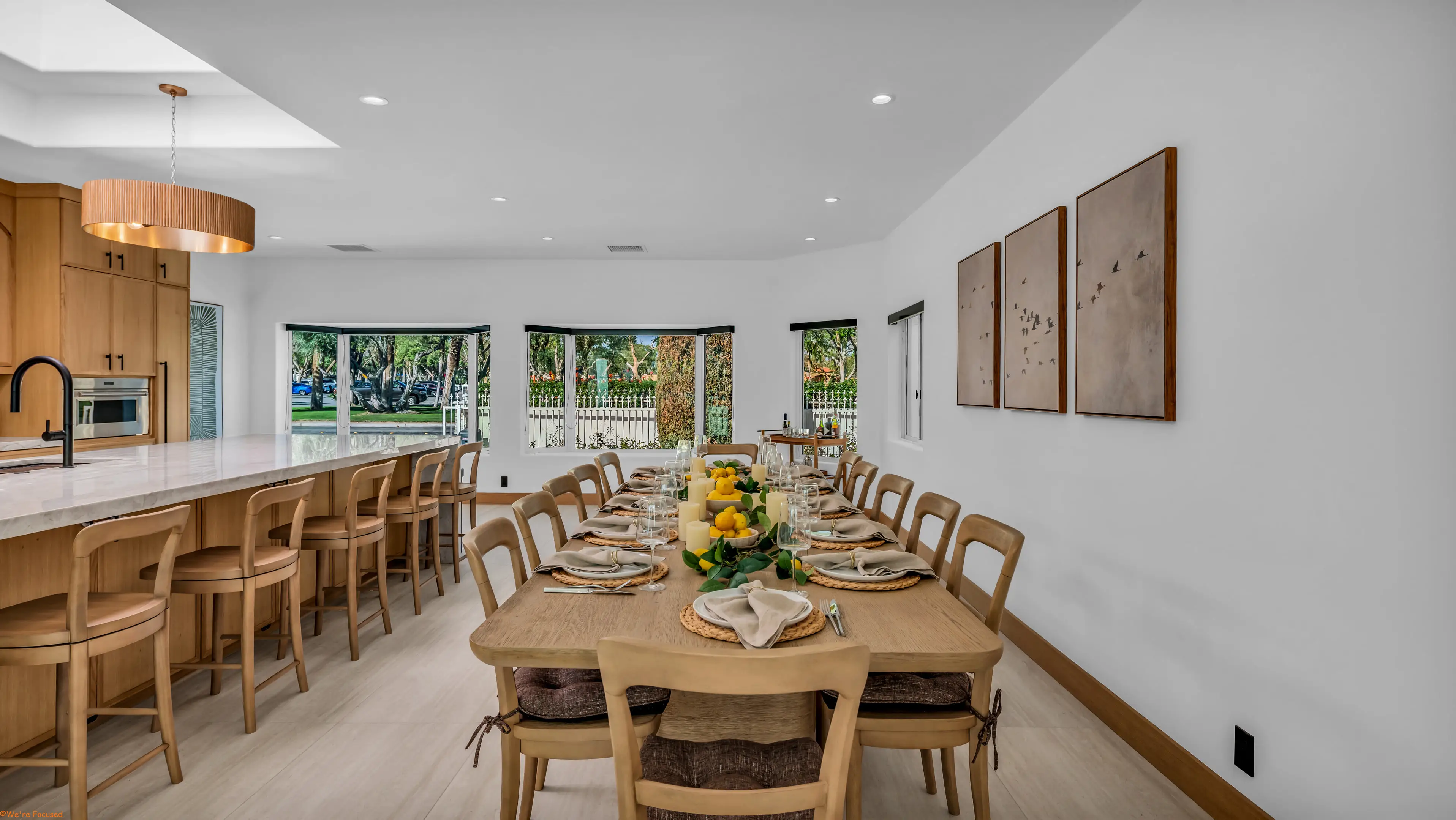 The dining table laid for twelve beside the kitchen island.