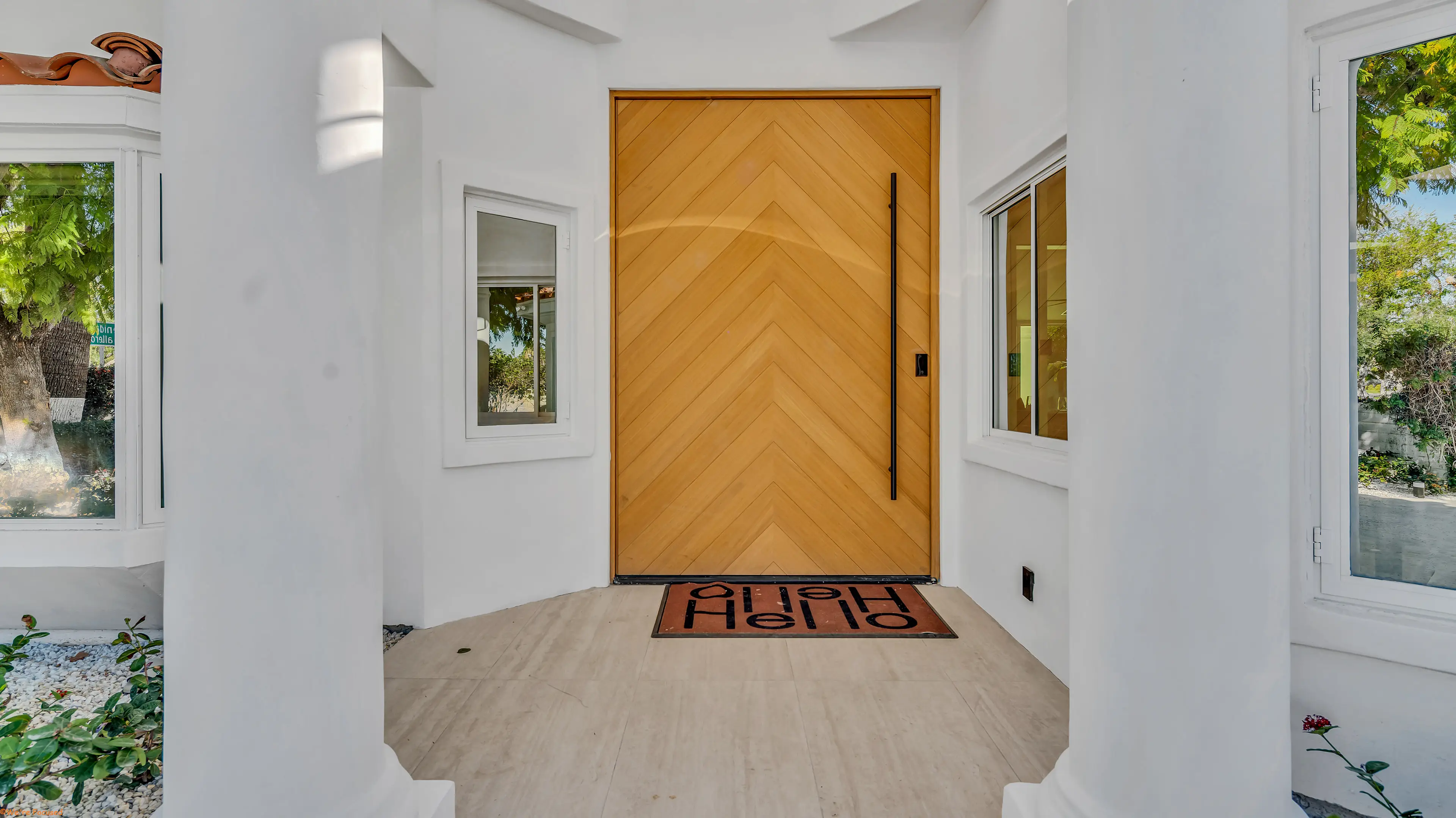 The front door in chevron oak, seen from inside the entry hall.
