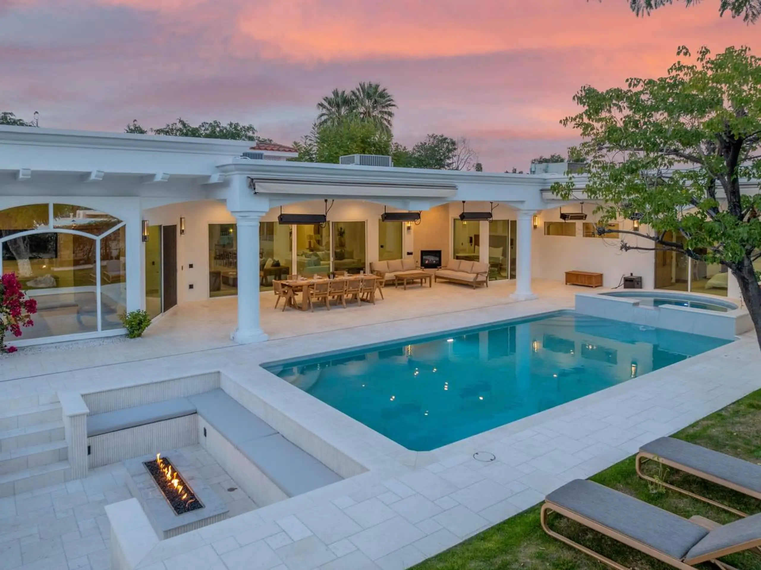 The pool, the sunken fire pit and the colonnade at dusk.