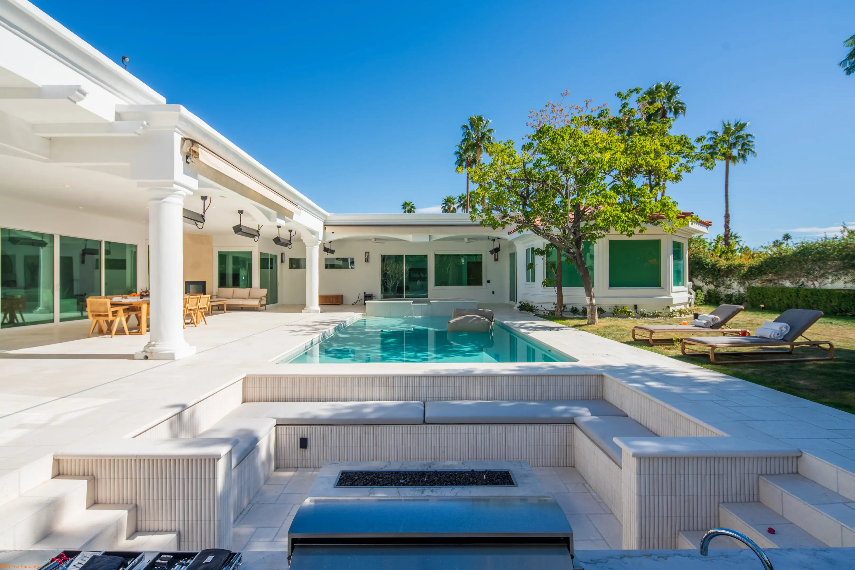 The pool, the sunken fire pit and the colonnade running the length of the courtyard.