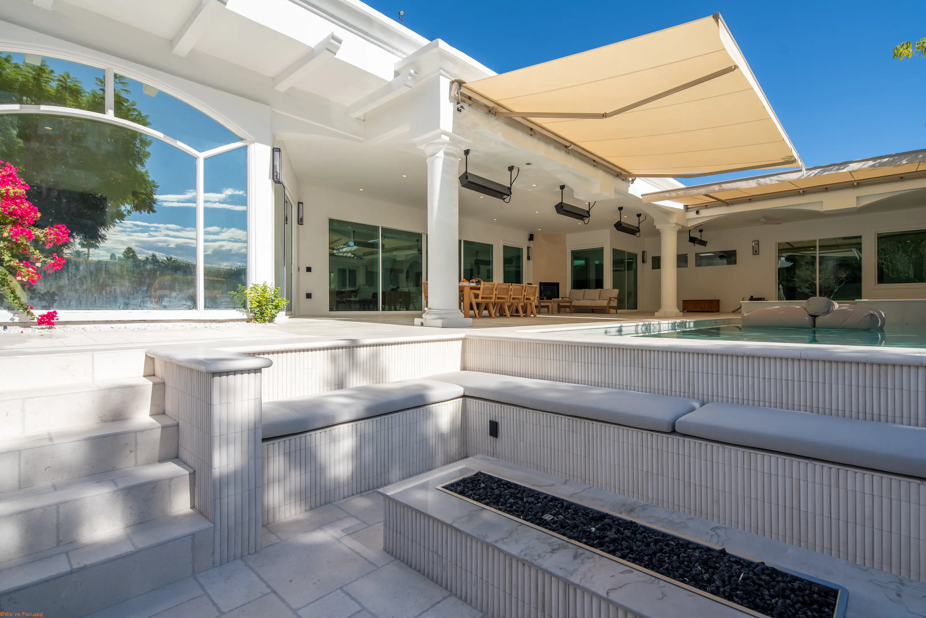 The terrace under its awning with the fire pit in the foreground.